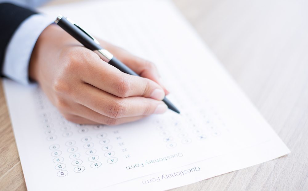 hand-filling-out-questionary-form